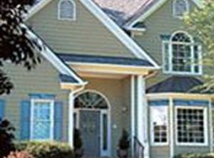 Gutter installation with seamless aluminum gutters along a gabled roofline.